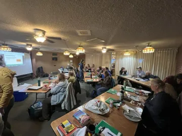 Outings Leader Trainees seated in a room with a slide on a screen