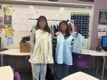 Teen hold dresses from THRIFT club at Righetti High