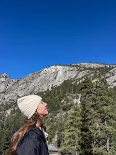 Young woman looking up at the view of Yosemite Valley