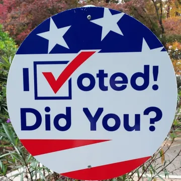 A circular sign with red, white and blue art and the words "I Voted! Did You?"
