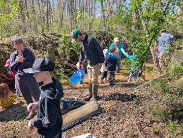 people exploring creek at bethania bottoms