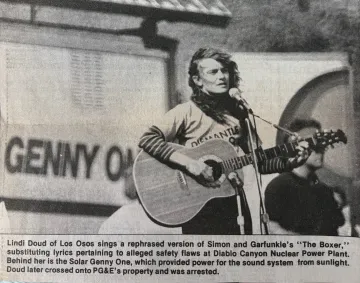 Newspaper photo of Lindi Doud performing at an anti-Diablo protest