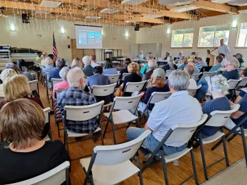 People listening to presentation at a Harbor Commission meeting