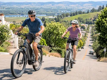 man woman riding ebikes uphill