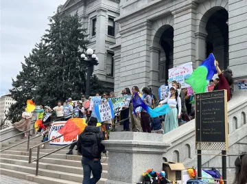 A group of volunteers and partners on the steps of the State Capitol 