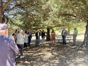 A group of people standing in the Chumash Heritage Garden