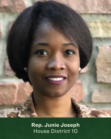 Headshot of Junie Joseph in front of a brick wall 