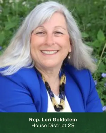 Headshot of Lori Goldstein in front of greenery 