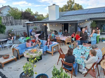 A group of people sitting at tables and chatting