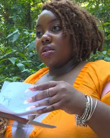 Kierra Southerland describes native plants during an outing at Historic Yates Mill County Park