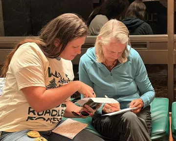 Two Roadless Rule rally participants work on comments together
