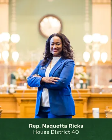 Headshot of Naquetta Ricks in front of the Colorado State House chambers 