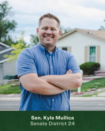 Headshot of Kyle Mullica in front of a beige house 