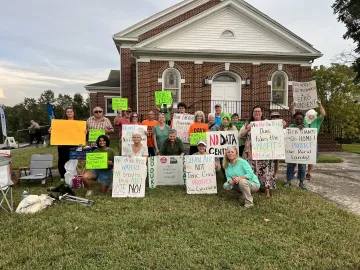 group holding signs protesting the proposed Duke Power Plant on the Yadkin