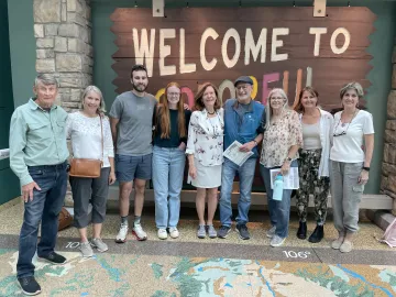 Outings attendees outside the Welcome to Colorado sign 