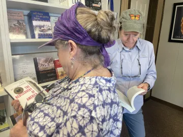 Outings attendees looking at books 