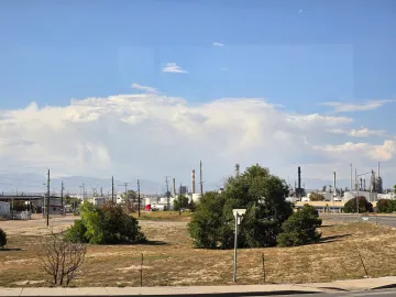 Passengers on the tour look through a camera to see a methane plume not visible to the naked eye at Suncor Refinery.