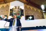 man standing at lecturn in a church