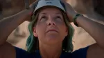 woman looking up with white helmet