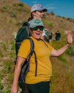 woman in yellow shirt turned and smiling at camera