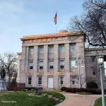 A photograph of the historic NC State Capitol building on a sunny day