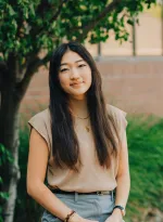 Picture of a young woman next to a tree