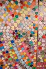 A spread of colorful origami fish pinned to a light purple board