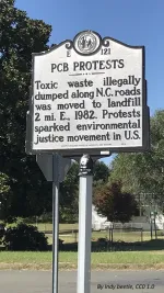 A historic marker sign denotes the location of protests in Warren County, NC, that sparked the environmental justice movement