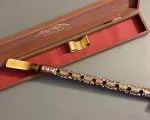 Close-up of a duduk, an ancient, double-reed woodwind instrument made from aged apricot wood, with its case