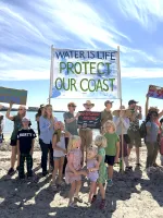 Hands Across the Sand (HATS) sign at Santa Barbara's 2026 West Beach event 