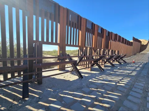 A section of the US-Mexico border wall with openings