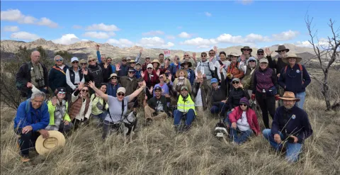A large group poses for a photo in the Santa Rita mountains