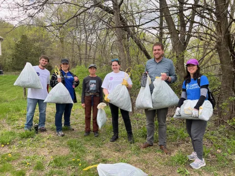 Picture of 6 volunteers holding garbage bags full of garlic mustard