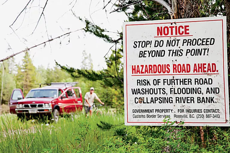 Unloading the bikes a mile from the U.S. border, where the Flathead River is slowly devouring the road.