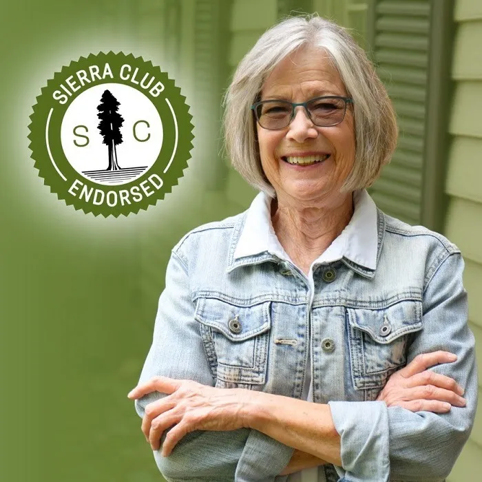 Debbie Helsley, a white woman with gray hair and glasses, smiling with a Sierra Club Endorsed seal.