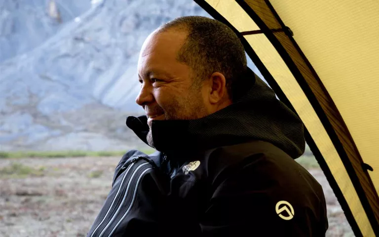 Profile of Ben Jealous sitting in a tent with the Arctic in the background.