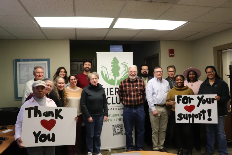 staff and members of SC executive committee posing with thank you for your support signs