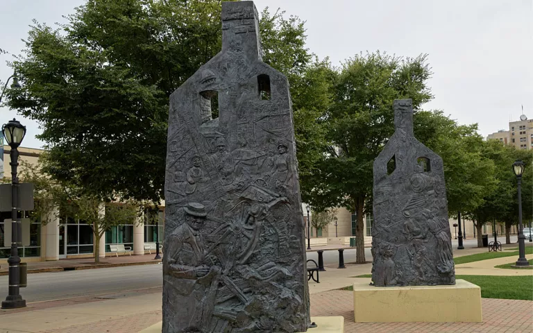 A portion of Preston Jackson's 2009 "Acts of Intolerance" statue in Springfield, Illinois' Union Square. The statue, in the form of two chimney columns that are all that remains from a burned-out building, commemorates the deadly Springfield race riot of 1908, in which white mobs attacked African-American residents, burned several homes, and lynched two black men.