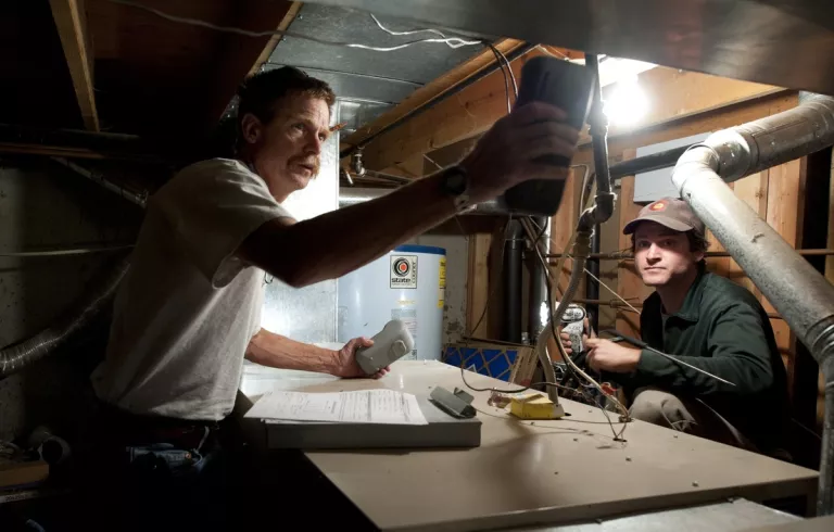 two people working on HVAC