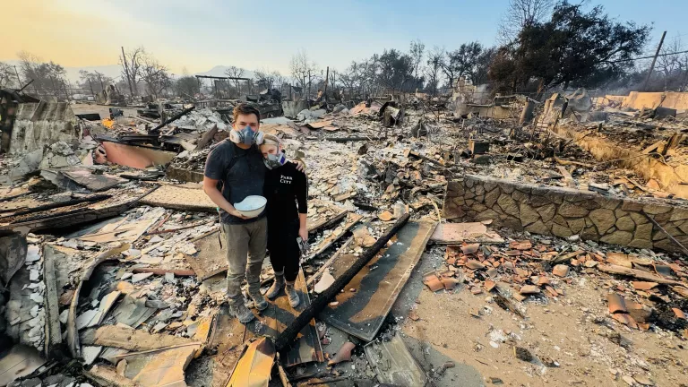 Megan Mantia stands in the ruins of her home