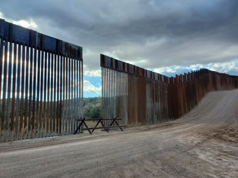 a section of the border wall with a gap and a vehicle barrier placed over the gap