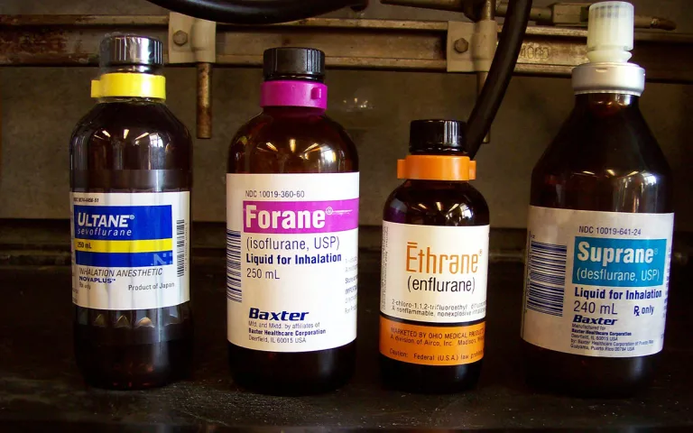 A line up of glass anesthesia bottles.