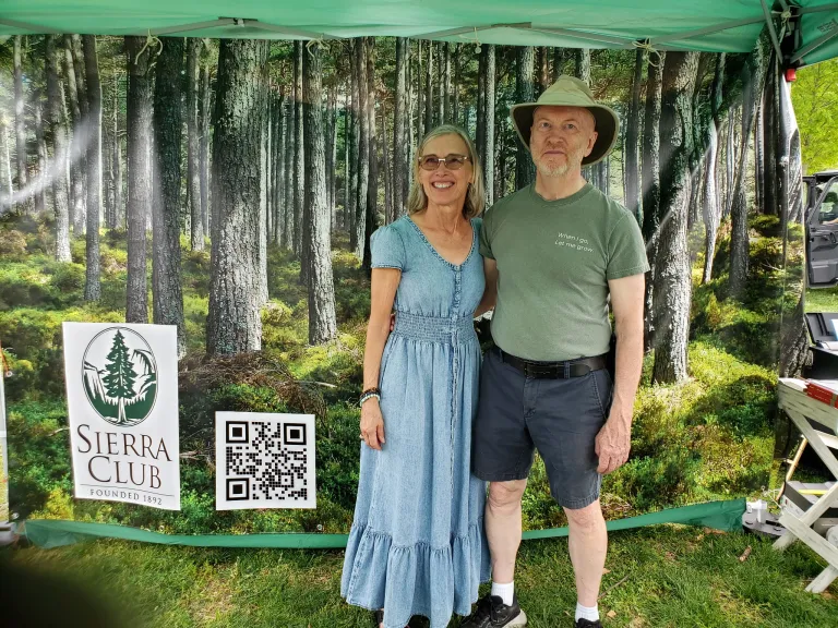 Regina Beck and John McFadden model in front of the Forest Photo Op