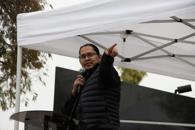 a person giving a speech and pointing 