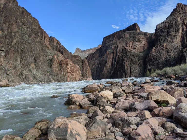 a white water rapid in a deep canyon