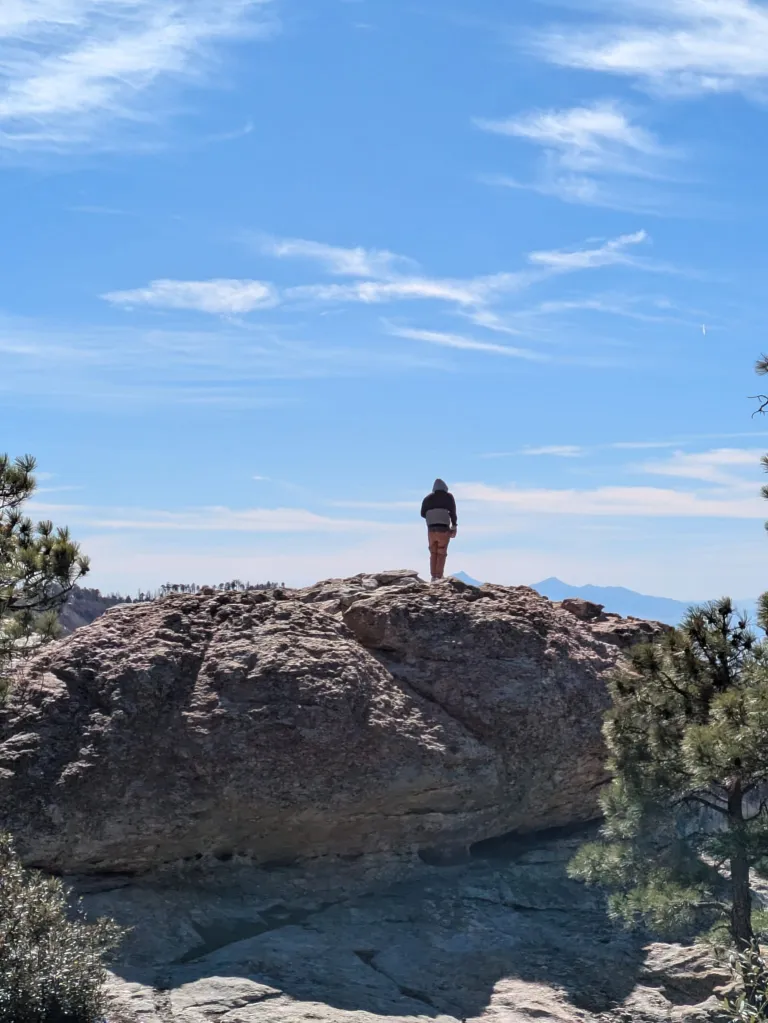 a person standing on a large boulder 