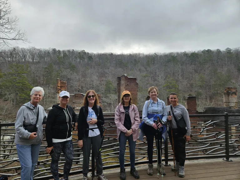Hikers stand in front of ruins at Sweetwater Creek Park
