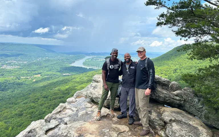 Sherman Neal II, the deputy director of the Sierra Club Military Outdoors campaign and a Marine Corps; Lornett Vestal, the Southeastern Military and Veterans Coordinator at the Sierra Club and a Naval officer; and Cris Poppe, an Army veteran, take break from the trail Sunset Rock during a hike at Lookout Mountain Battlefield.