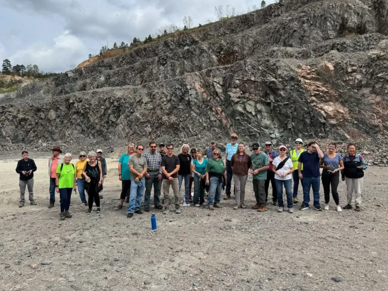 Folks gather for a photo at a rock quarry in Augusta