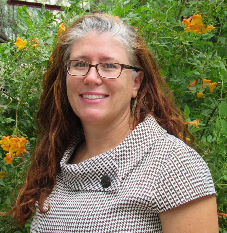 a person in front of a green lush background
